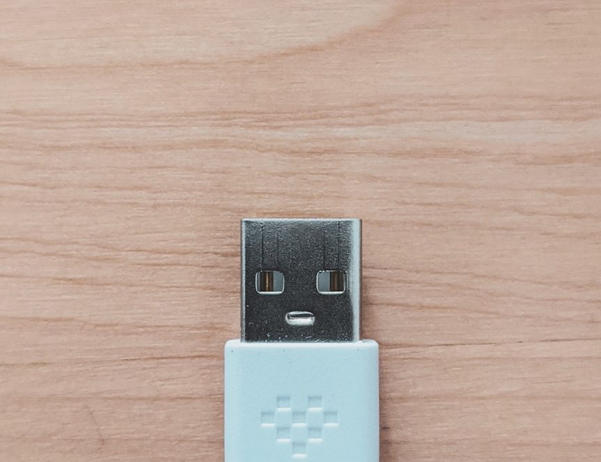 white usb flash drive on brown wooden table
