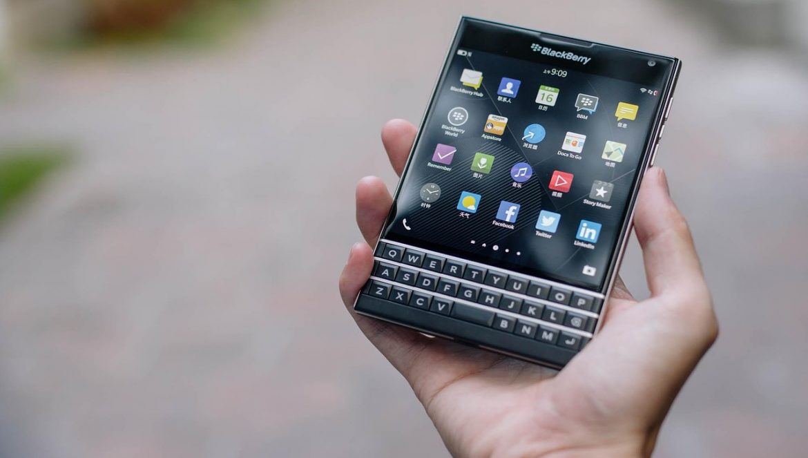 a person holding a blackberry passport